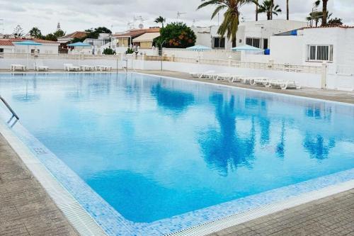 a large swimming pool with blue water at Calma & Mar in Arona