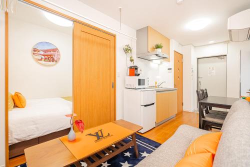 a living room with a couch and a table at KYARA HOTEL 亀戸a in Tokyo