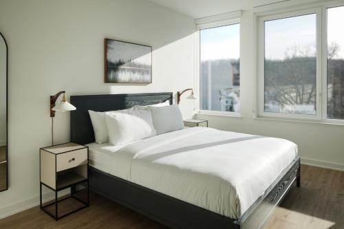 a bedroom with a large bed and a window at ROOST Kelly Drive in Philadelphia