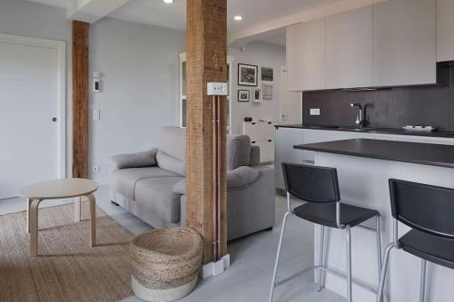 a kitchen with a couch and a table and chairs at EARRA - Casa Fabiola, centro y a 2 min de la playa in Zarautz