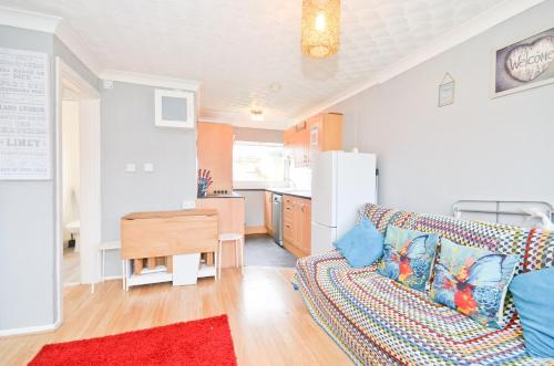a living room with a couch and a kitchen at 32 Sandown Bay Holiday Centre in Brading