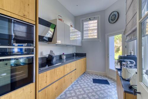 a kitchen with a sink and a counter top at La Villa Authentique - Jacuzzi, babyfoot in Bourbourg