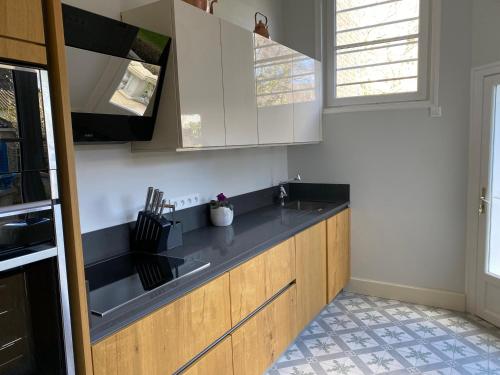 a kitchen with a sink and a counter top at La Villa Authentique - Jacuzzi, babyfoot in Bourbourg