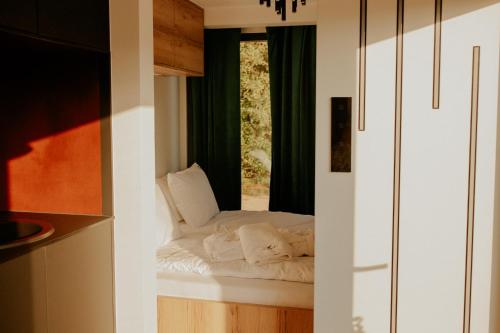a room with a window with a bed in it at Uroczy mały domek z jacuzzi in Długosiodło