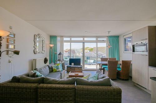 a living room with a couch and a table at Appartement Seinpost 26 - Callantsoog in Callantsoog