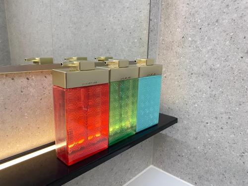 a pile of colorful books sitting on a shelf at Hotel Toin Kyoto in Kyoto