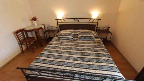 a bed in a small room with a table and chairs at Apartment Malinska, Primorje-Gorski Kotar 20 in Sveti Vid-Miholjice