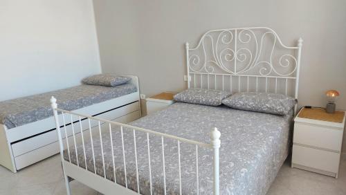 a bedroom with two beds and a crib at Lovehome in San Giovanni Teatino