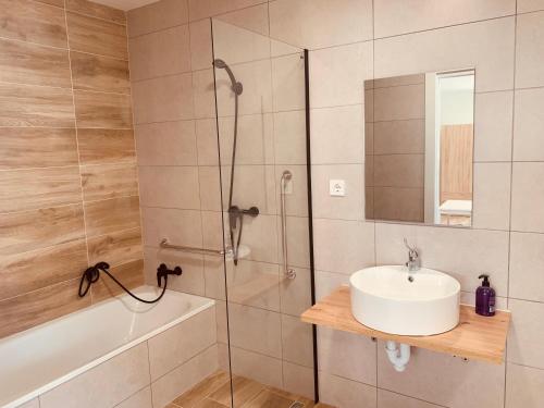 a bathroom with a shower and a sink and a tub at LURGORRI APARTAMENTOS by Gernihost in Guernica y Luno