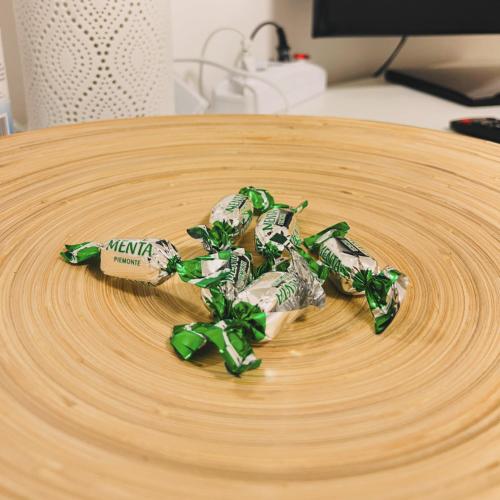 a round wooden table with a green ribbon on it at SHUBY HOME in San Pietro Vernotico