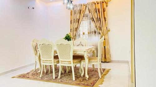 a dining room with a table and chairs at House 5 in Ilorin