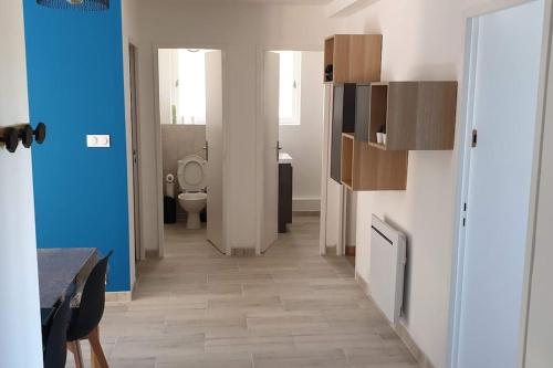 un couloir d'une salle de bains pourvue de toilettes. dans l'établissement Le Saint Lazare, à Montélimar