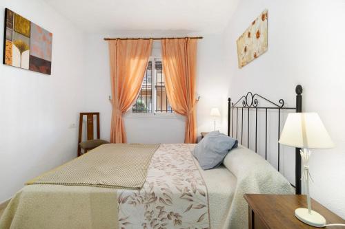 a bedroom with a bed and a window at Altamar in Novo Sancti Petri
