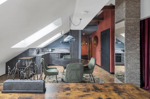 a kitchen and dining room with a table and chairs at Cozy Penthouse in Vilnius