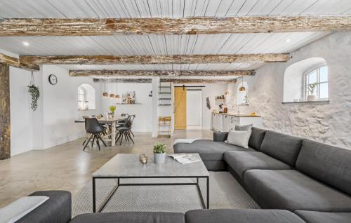 a living room with a couch and a table at Lovely Apartment In Nykøbing Sj in Lumsås