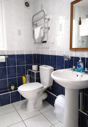 a bathroom with a toilet and a sink at Three bed Holiday Home in Hayle