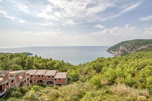 uma casa numa colina com vista para o oceano em Snežna Kraljica em Sutomore