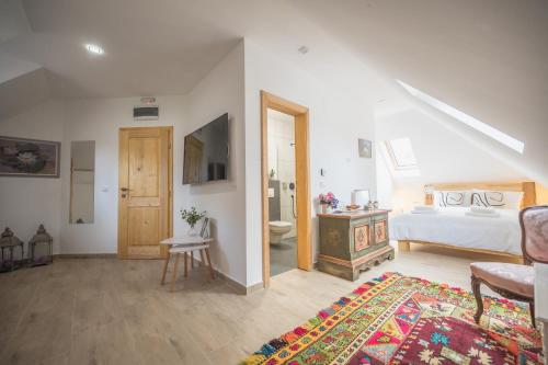 a white bedroom with a bed and a bathroom at Konak Lecic in TrÅ¡iÄ‡