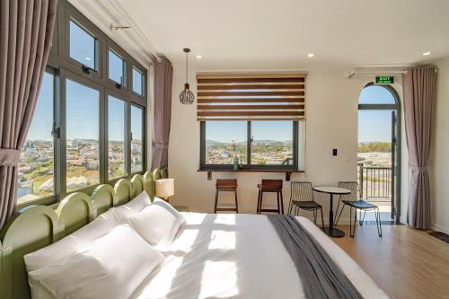 a bedroom with a bed and a table with chairs at Storij Home & Coffee in Khu Chi Lăng