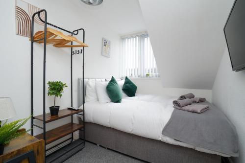 a bedroom with a bed with green pillows at Beautiful House with Parking in Wibsey