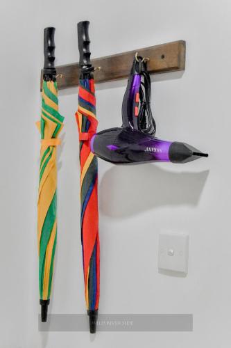two colorful umbrellas hanging on a wall at Wild River Side in Udawalawe