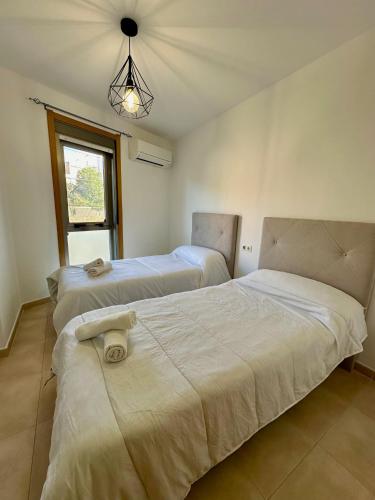 a bedroom with two beds and a window at Apartamento Algaida REF.004 in Oropesa del Mar
