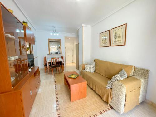 a living room with a couch and a table at Apartamentos Caribe Marina D’Or 3000 in Oropesa del Mar