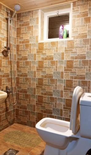 a bathroom with a toilet and a window at Sunset Roof apartment in Madaba