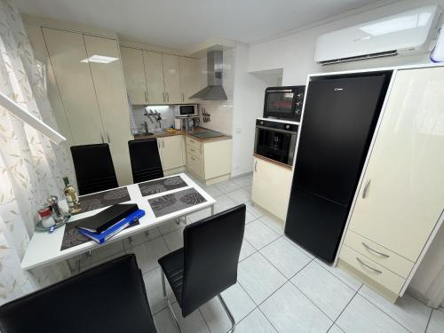 a kitchen with a table with chairs and a refrigerator at Edificio Gloria in Los Cristianos