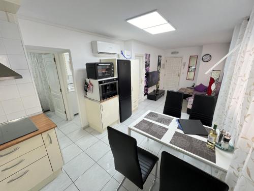 a kitchen and living room with a table and chairs at Edificio Gloria in Los Cristianos