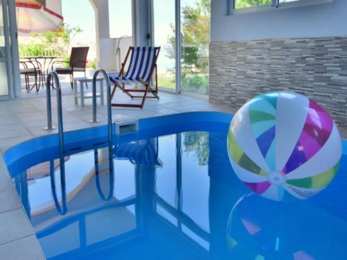 a pool with a beach ball and a volley ball at DOROTEA3 in Makarska