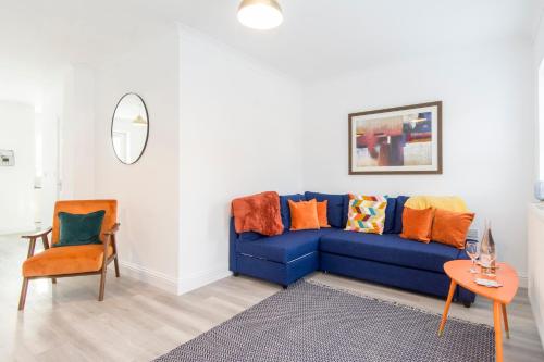 a living room with a blue couch and a table at Host & Stay - Davies Close in Market Harborough
