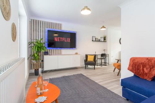 a living room with a tv and a blue couch at Host & Stay - Davies Close in Market Harborough