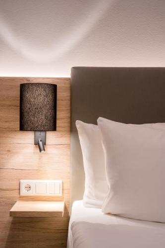 a bedroom with a bed and a tv on the wall at Best Western Hotel Lippstadt in Lippstadt
