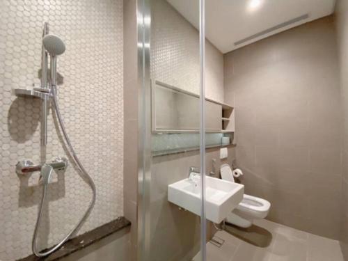 a bathroom with a toilet and a sink and a shower at LUCENTIA KUALA LAMPUR in Kuala Lumpur