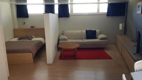 a living room with a couch and a table at Studio Astrid in Mechelen