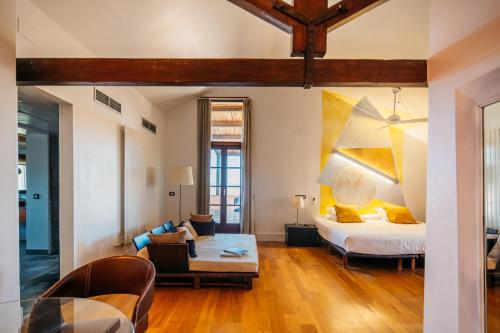 - un salon avec un lit et une table dans l'établissement Hotel Boutique Mas Passamaner, à La Selva del Camp