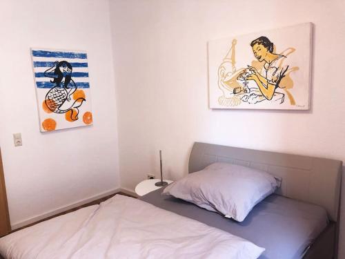 a bedroom with a bed and two pictures on the wall at Apartment in Innenstadt Bielefeld in Bielefeld