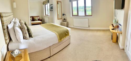 a bedroom with a large bed and a television at Roseberry House in Newcastle Emlyn