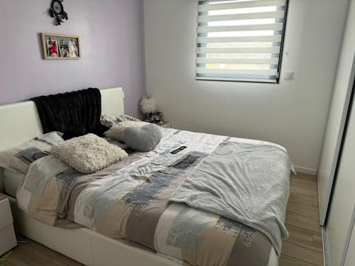 a bed with two pillows on it in a bedroom at Villa accueillante à Millas avec piscine privée et jacuzzi in Millas