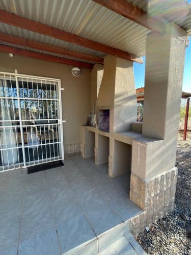 an outdoor patio with a porch and a window at Harmonie in Prieska