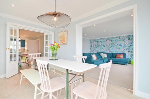 a dining room and living room with a table and chairs at Princes Esplanade in Cowes