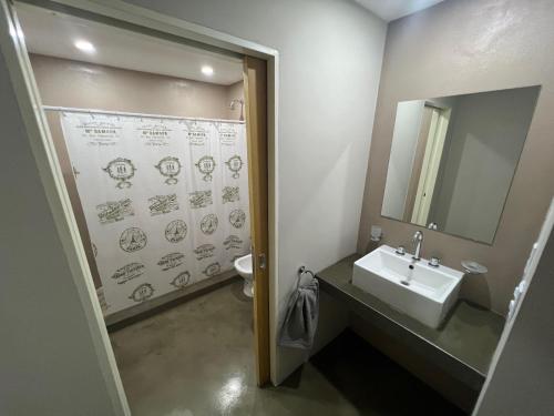 a bathroom with a sink and a mirror at Finca Las Acacias in Marcos Paz