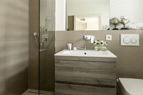 a bathroom with a sink and a mirror at Home-by-Sea in Westerland (Sylt)