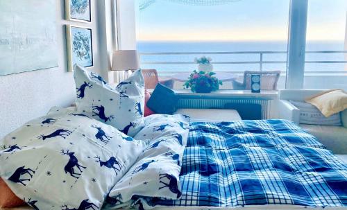 a bedroom with a bed and a view of the ocean at Apartment am Meer in Sierksdorf