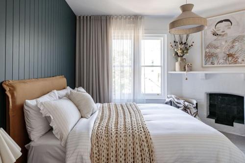 a bedroom with a large bed and a fireplace at Large Apartment in Launceston- Timeless Luxury in Launceston
