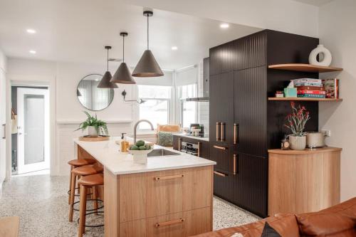 a kitchen with wooden cabinets and a kitchen island at Mulgrave Street Cottage- renovated comfort in Kings Park