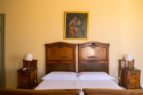 a bedroom with a bed and a painting on the wall at Palazzo Lucangeli in Porto Recanati