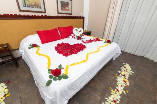 a bed with a heart made out of flowers at Sangay Spa Hotel in Baños