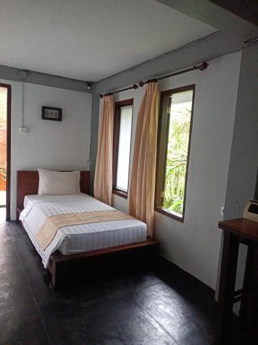 Una cama o camas en una habitación de Astana Swaha Villa